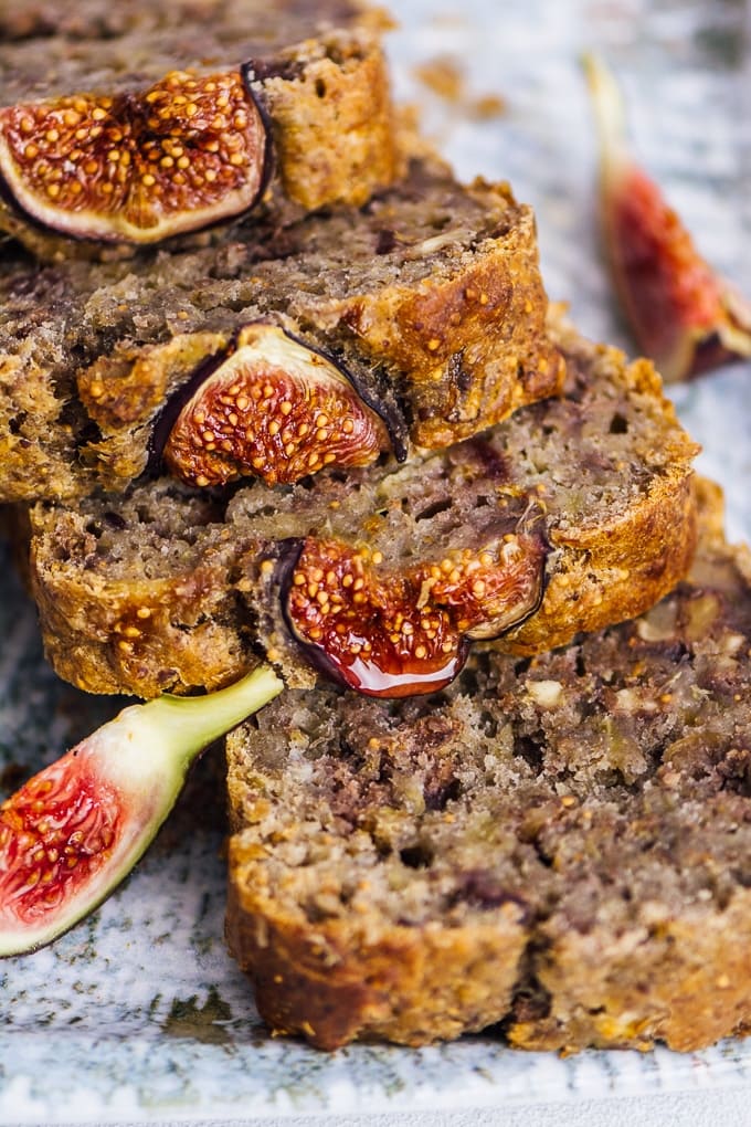 Vegan fresh fig bread with walnuts sliced on a ceramic plate.