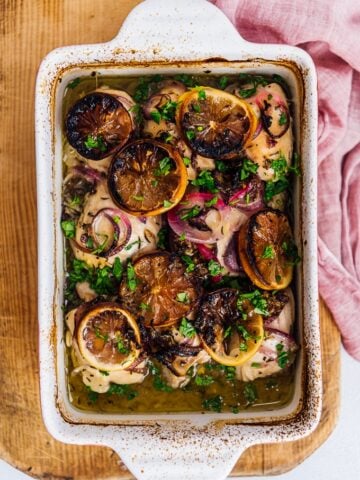 baked lemon chicken with onions in a casserole pan