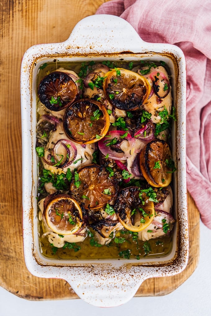 Easy Baked Lemon Chicken Thighs. Healthy and perfect meal for special occasions! #chickenrecipe #bakedchicken #healthychicken #roastedchicken baked lemon chicken with onions in a casserole pan