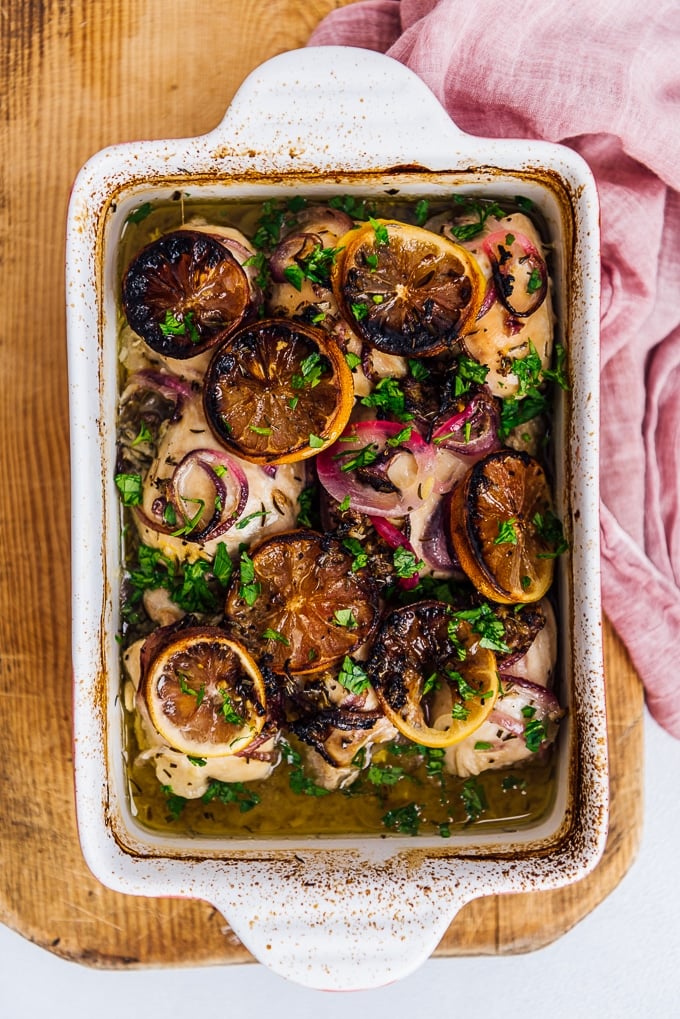 baked lemon chicken with onions in a casserole pan