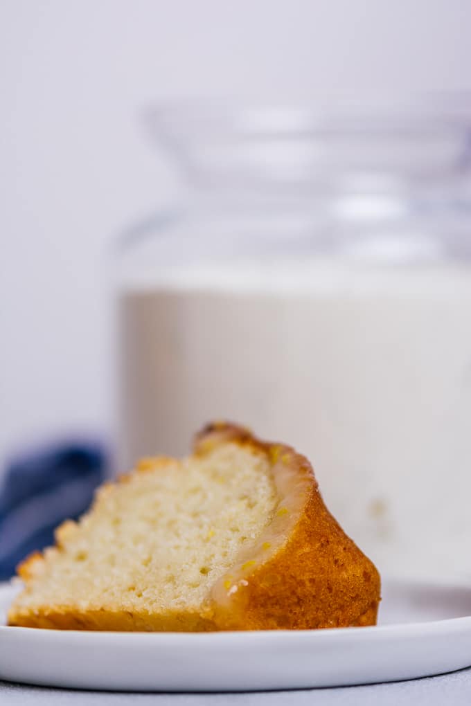 A slice of lemon cake made with homemade lemon cake mix on a white plate.