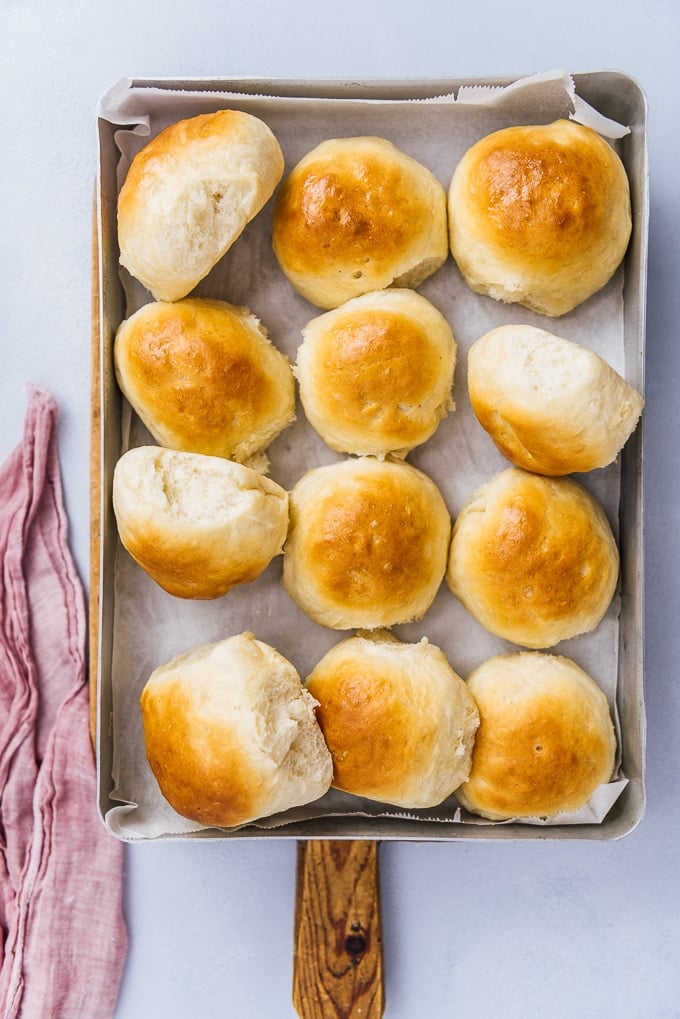 newly baked homemade yeast rolls in a rectangular baking pan.