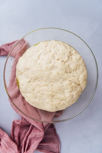 yeast dough first rise in a glass bowl