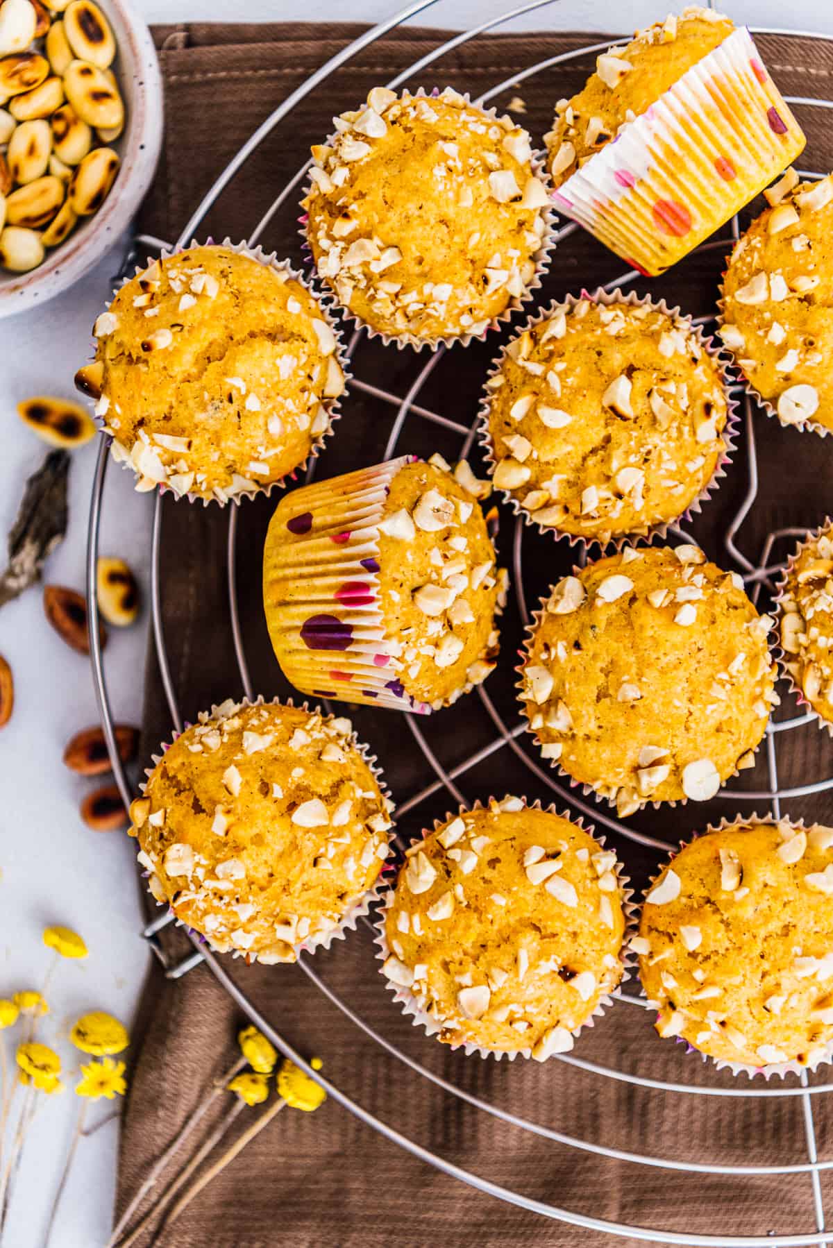 Pumpkin muffins with cake mix on a cooling rack and peanuts on the side.