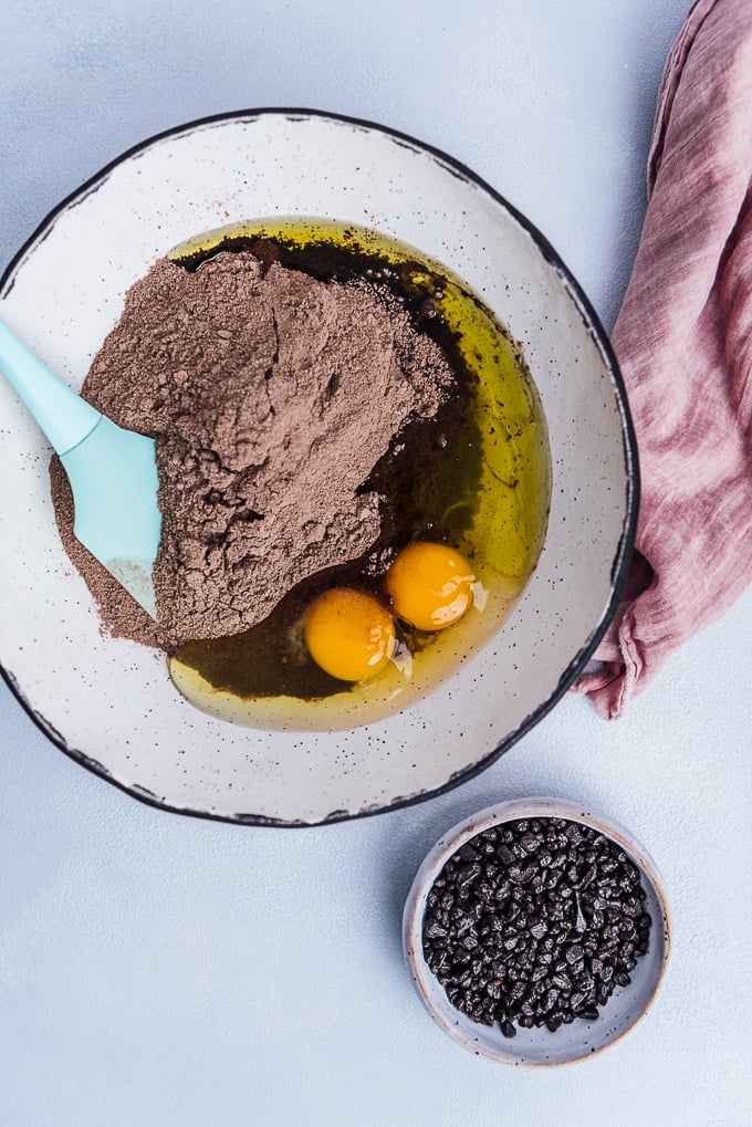 Making chocolate cookies out of chocolate cake mix, oil and eggs in a large bowl