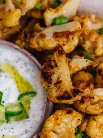 Baked cauliflower wings served with a yogurt sauce