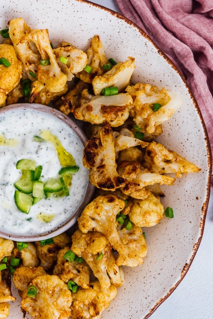 Baked cauliflower wings served in a ceramic bowl.