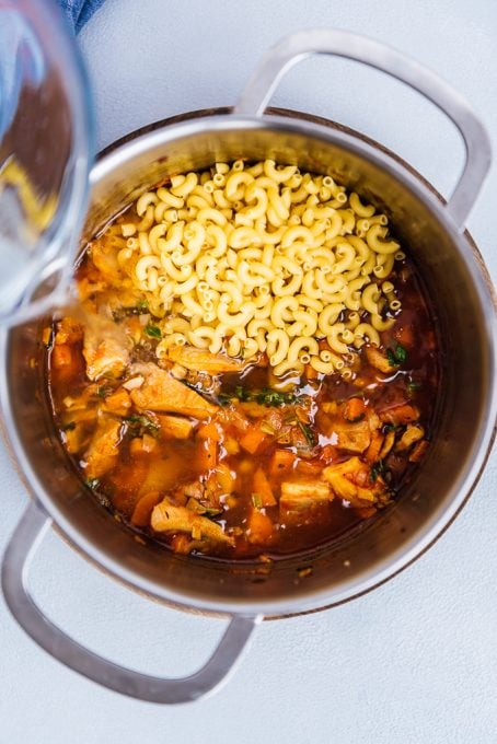 Pouring water over oyster mushroom noddle soup