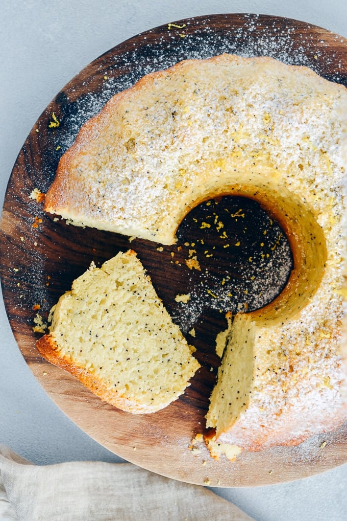 Lemon poppy seed bundt cake sliced on a wooden board