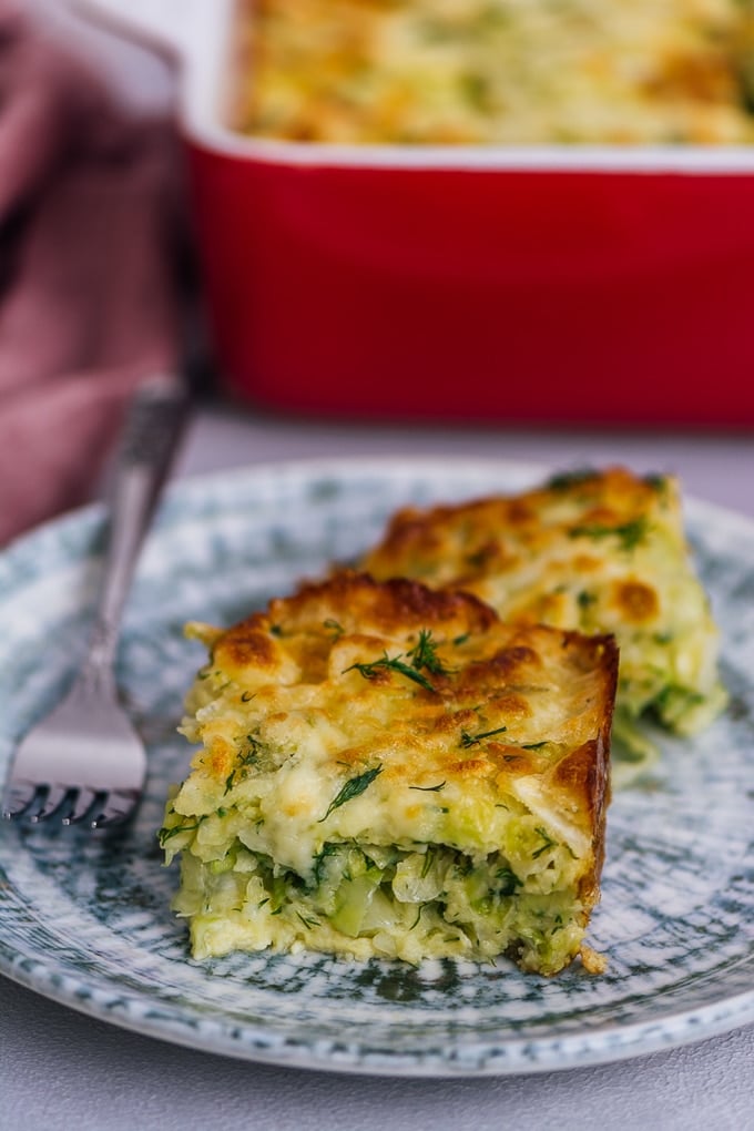Cheesy cabbage casserole slice on a plate.