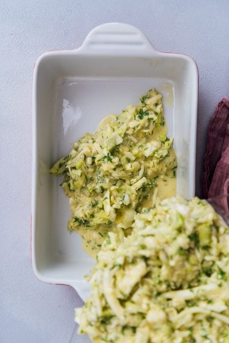 Pouring the batter of cabbage and cheese in a baking pan