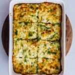 Baked vegetarian cheesy cabbage casserole topped with a golden top in a baking pan.