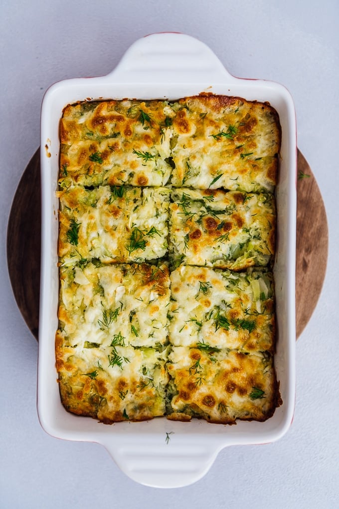 Baked vegetarian cheesy cabbage casserole topped with a golden top in a baking pan