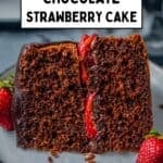 Chocolate cake slice with strawberry center and chocolate glaze.