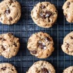 Chocolate chunk tahini cookies with Turkish coffee topped with sea salt on a cooling rack.