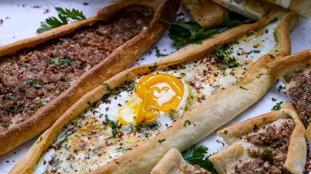 Pide with ground beef and cheese with an egg topping.