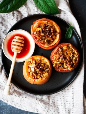 Healthy baked apples with walnuts and cinnamon served with a simple beet syrup on the side