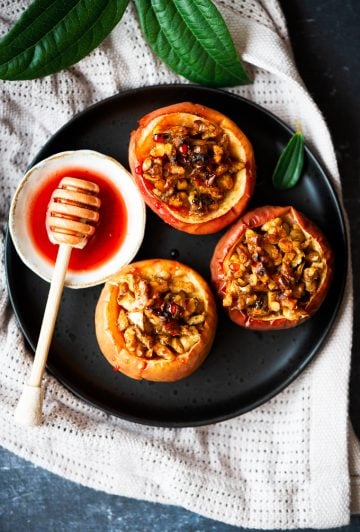 Healthy baked apples with walnuts and cinnamon served with a simple beet syrup on the side