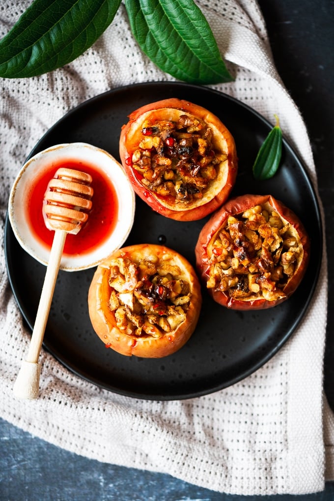 Healthy baked apples with walnuts and cinnamon served with a simple beet syrup on the side.