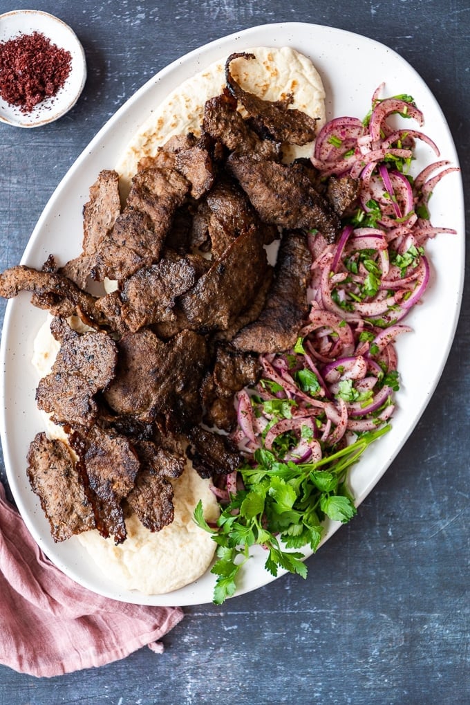 Homemade Doner Kebab on a white plate with sumac onions