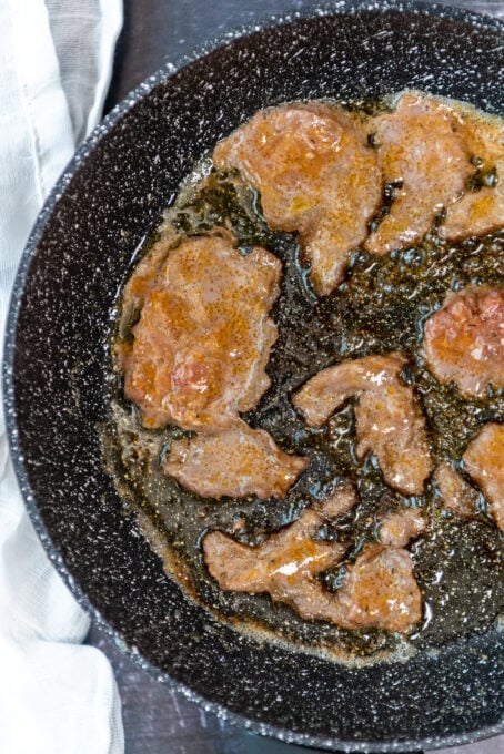 Frying doner slices in a non stick pan.