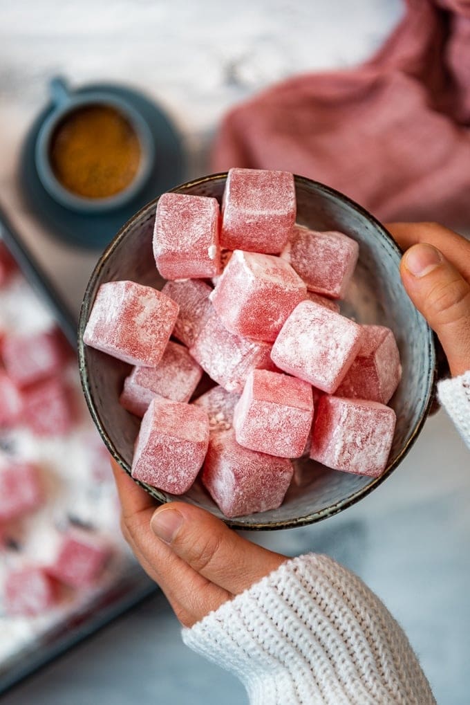 Holding rose Turkish Delight Lokum in a bowl. 