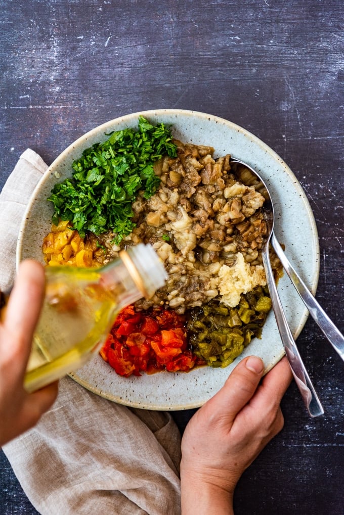 Making Turkish baba ganoush recipe with olive oil and roasted eggplants and peppers