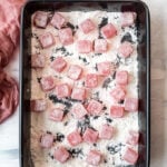 Turkish Delight lokum cubes coated with cornstarch and powdered sugar in a black rectangular pan