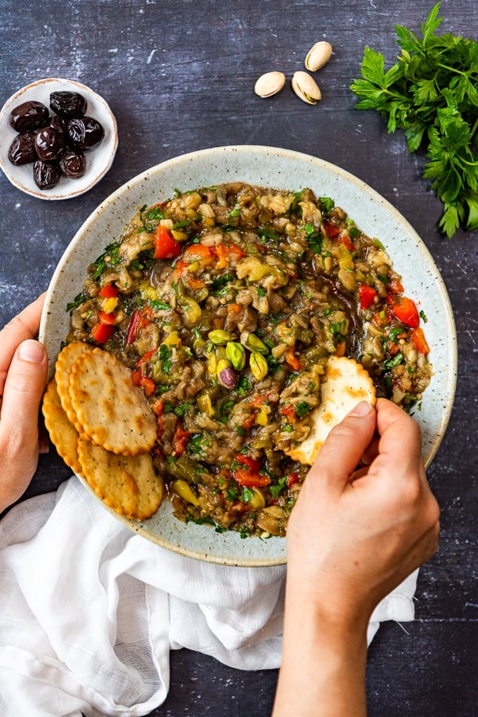 Dipping crackers into a bowl of baba ganoush without tahini.