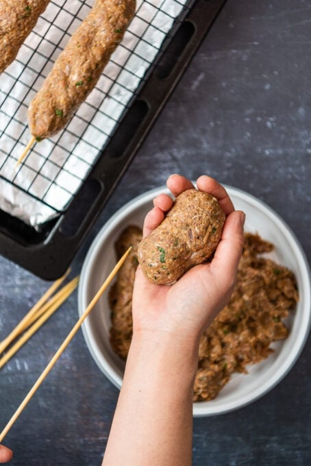 shaping kofta kebabs on wooden skewers