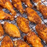 Baked chicken wings on a rack.