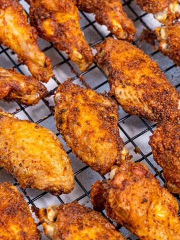 Baked chicken wings on a rack.