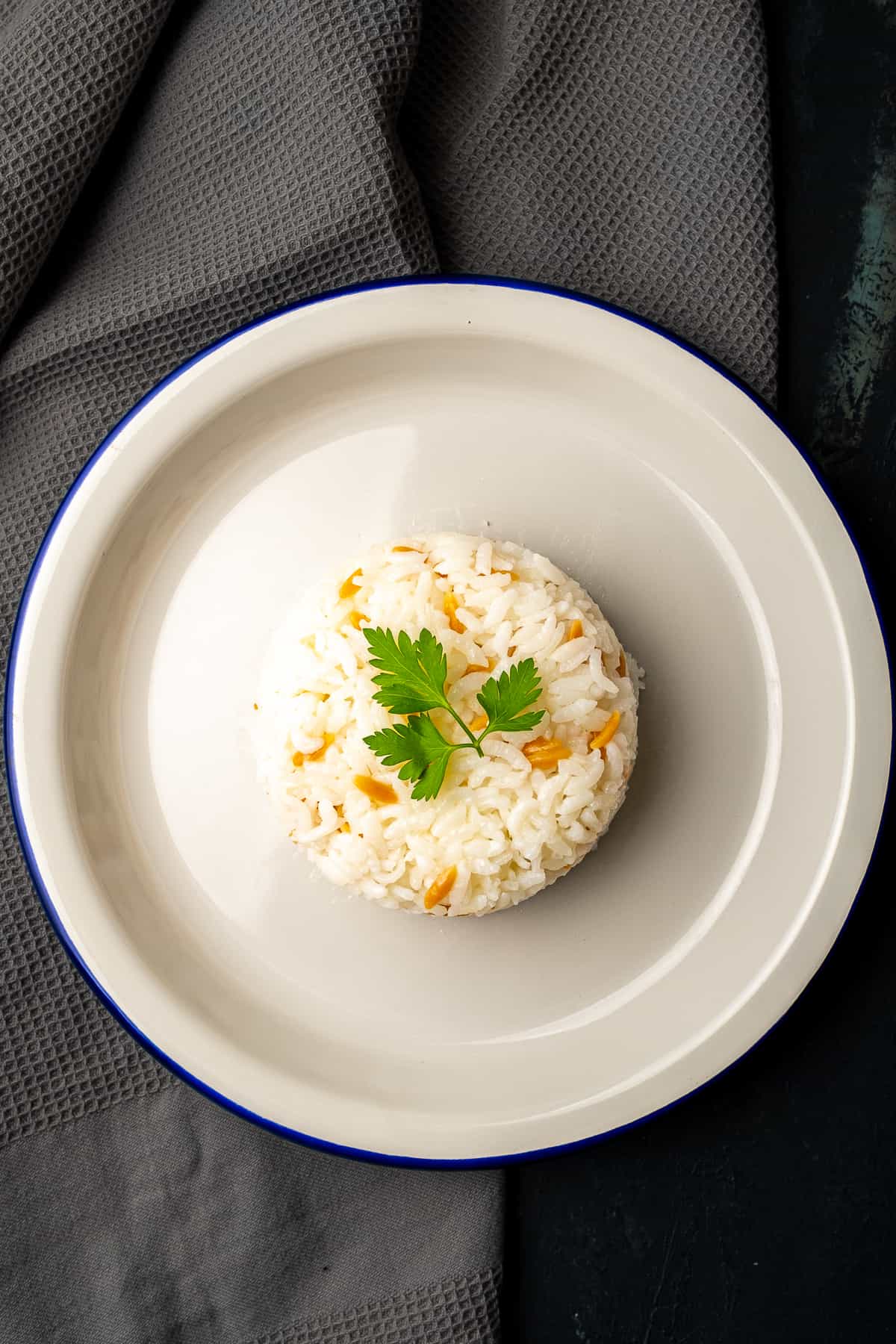 Turkish rice served on a white plate, garnished with parsley.