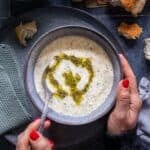 Pinterest image showing a bowl of Turkish Yogurt Soup (Yayla Çorbası) with butter-mint sauce, held in hands, labeled “Yayla Corbasi – Turkish Yogurt Soup” from giverecipe.com.
