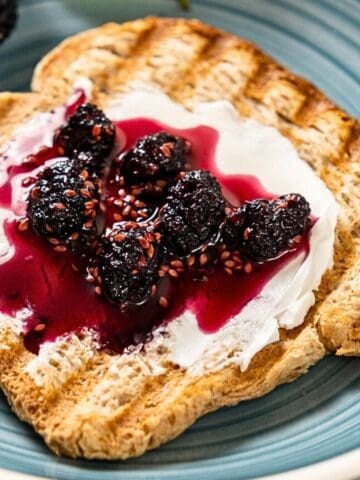 Mulberry jam on a slice of toasted bread.