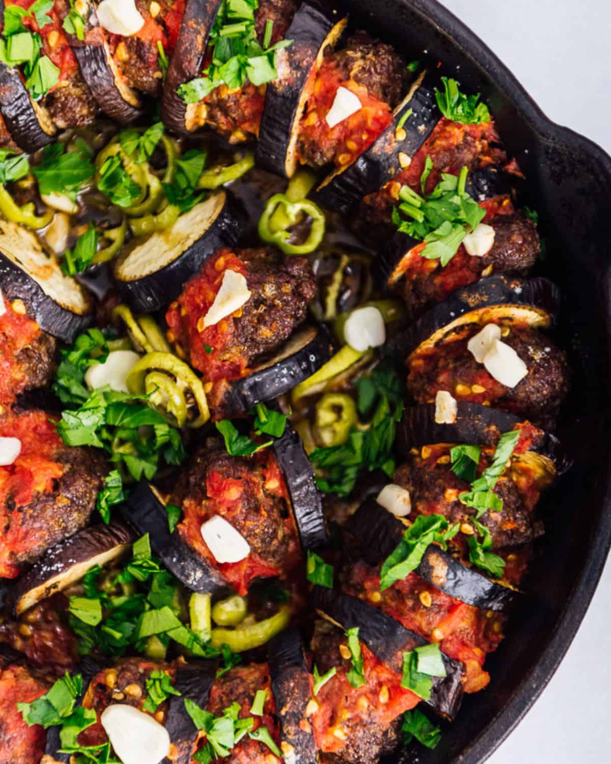 An image of juicy eggplant kebab baked with garlic, parsley, and green peppers.