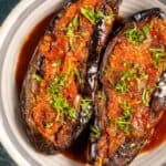 Pinterest pin showing Imam Bayildi, a Turkish stuffed eggplant dish with tomato sauce and fresh herbs, from giverecipe.com.