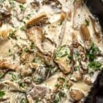 Creamy oyster mushroom sauce cooking in a pan, with sautéed oyster mushrooms, herbs, and a rich, velvety texture.