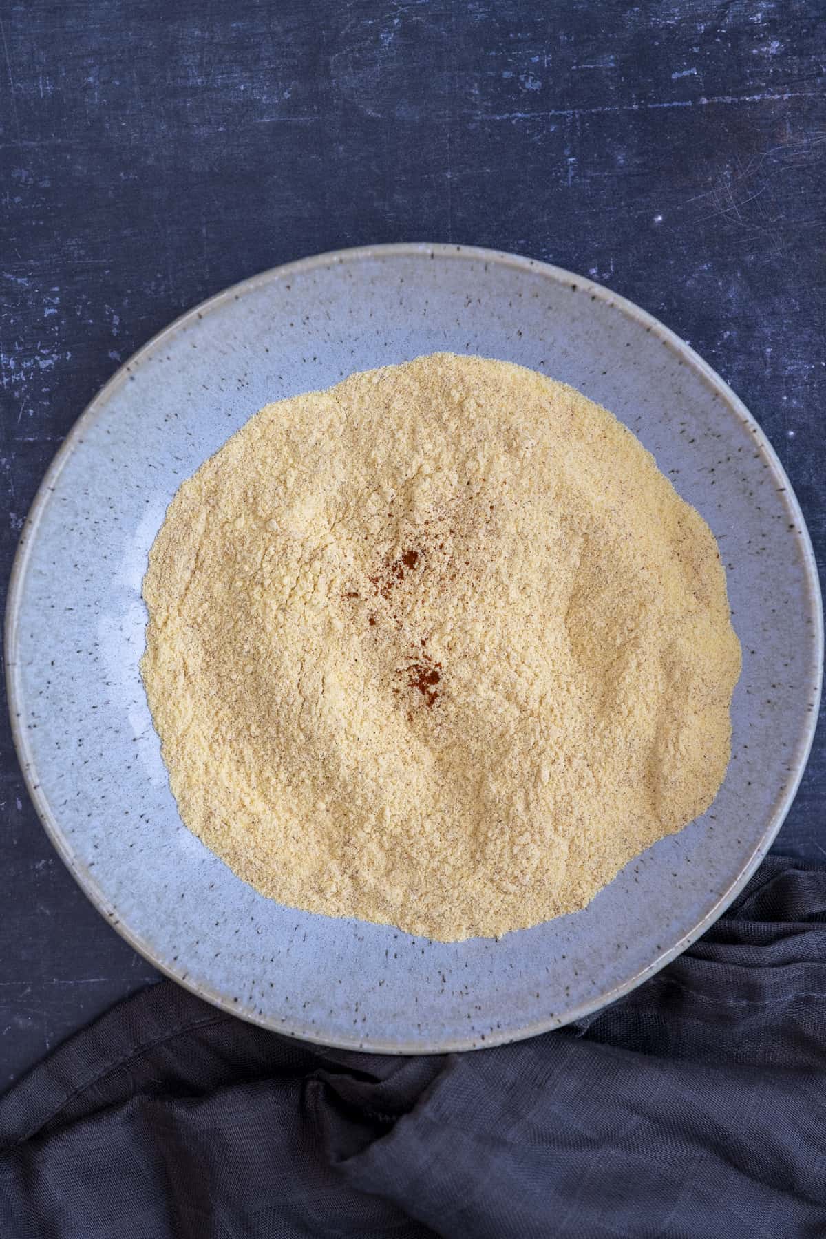 Cornmeal mixture in a blue bowl.