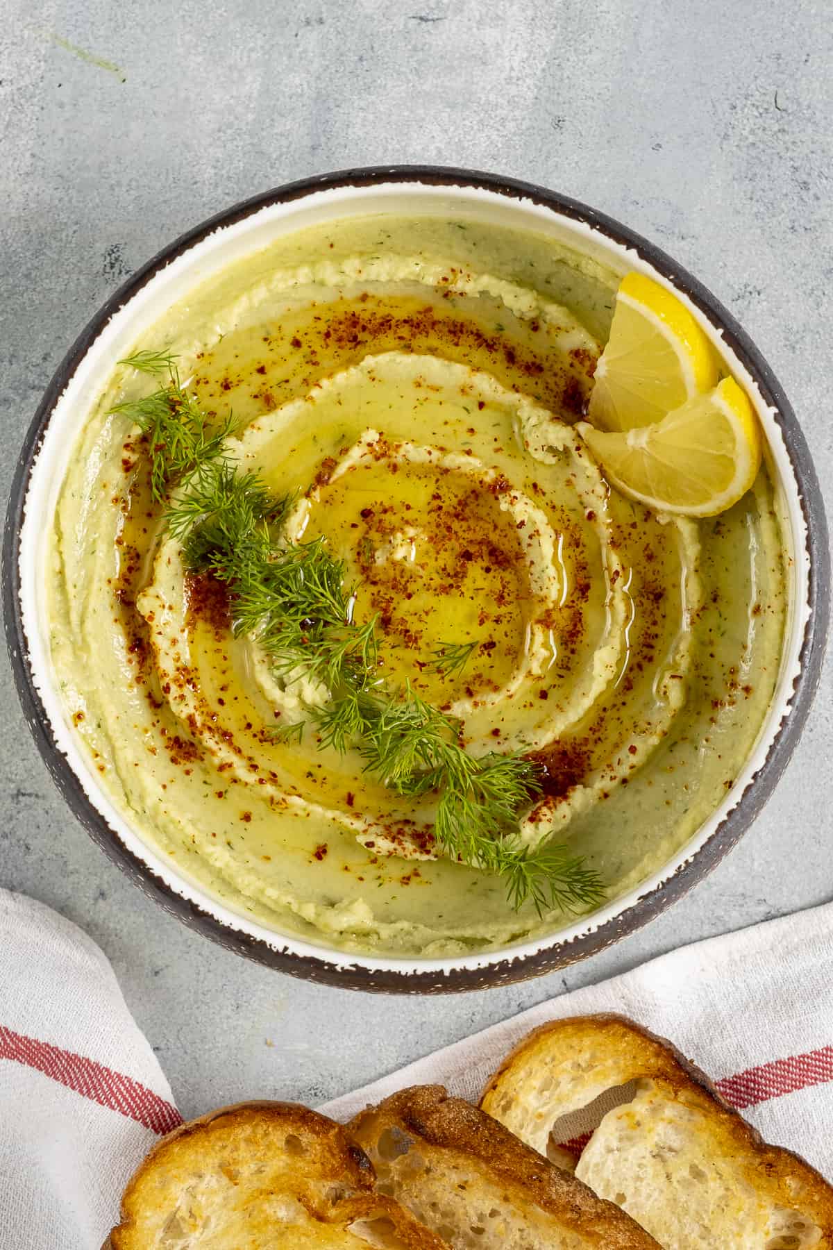 Fava bean dip garnished with red pepper flakes and fresh dill.
