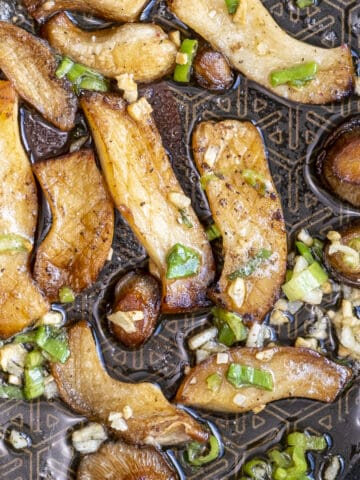 King oyster mushoom slices cooked with garlic and green onions.