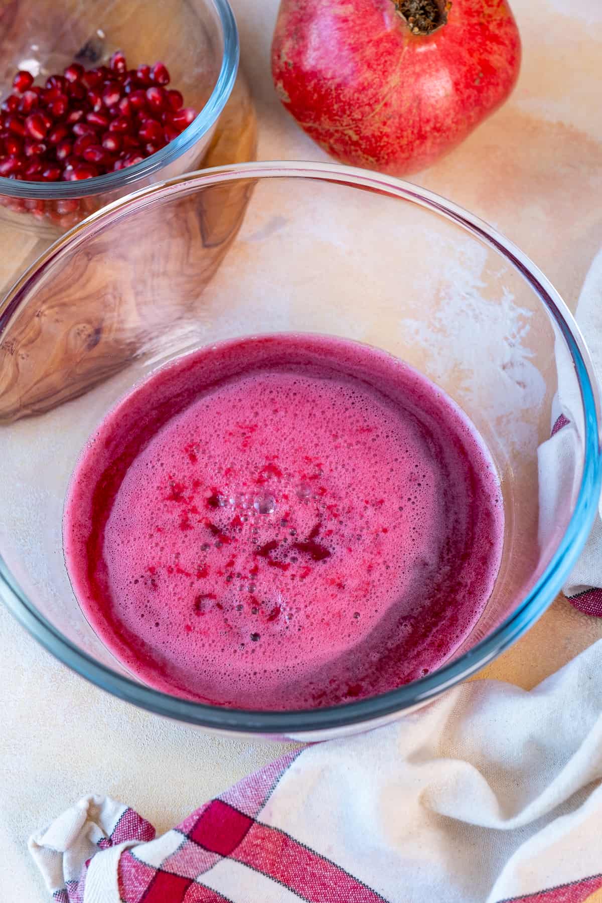 Fresh pomegranate juice in a glass bowl.