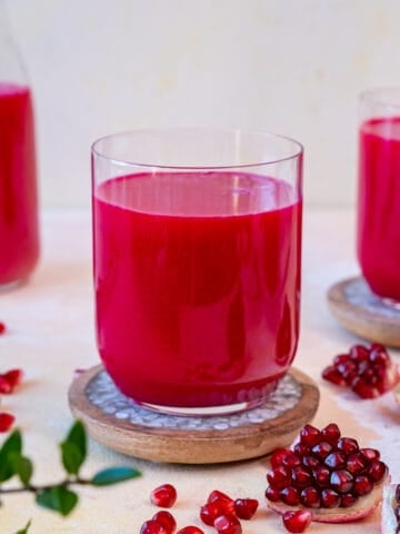 Pomegranate juice in glasses and in a jug.