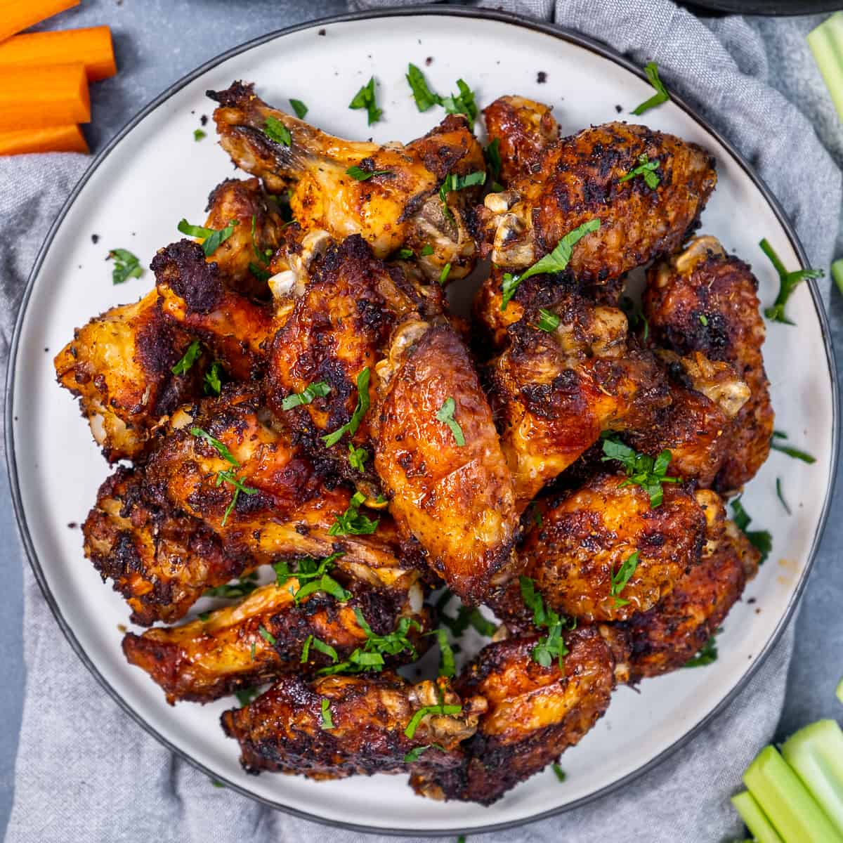 Fried chicken wings garnished with parsley on a plate.