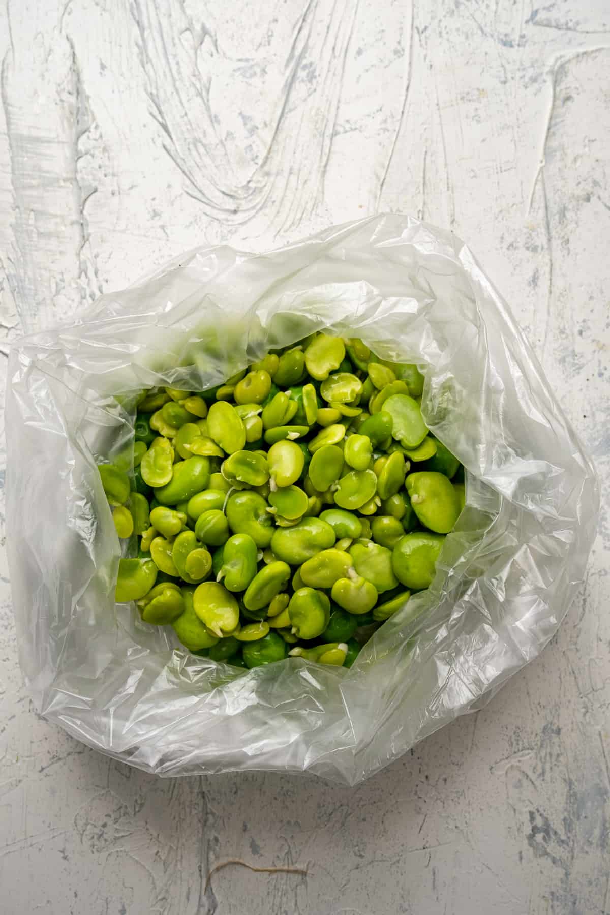 Blanched fresh fava beans in a freezer bag.