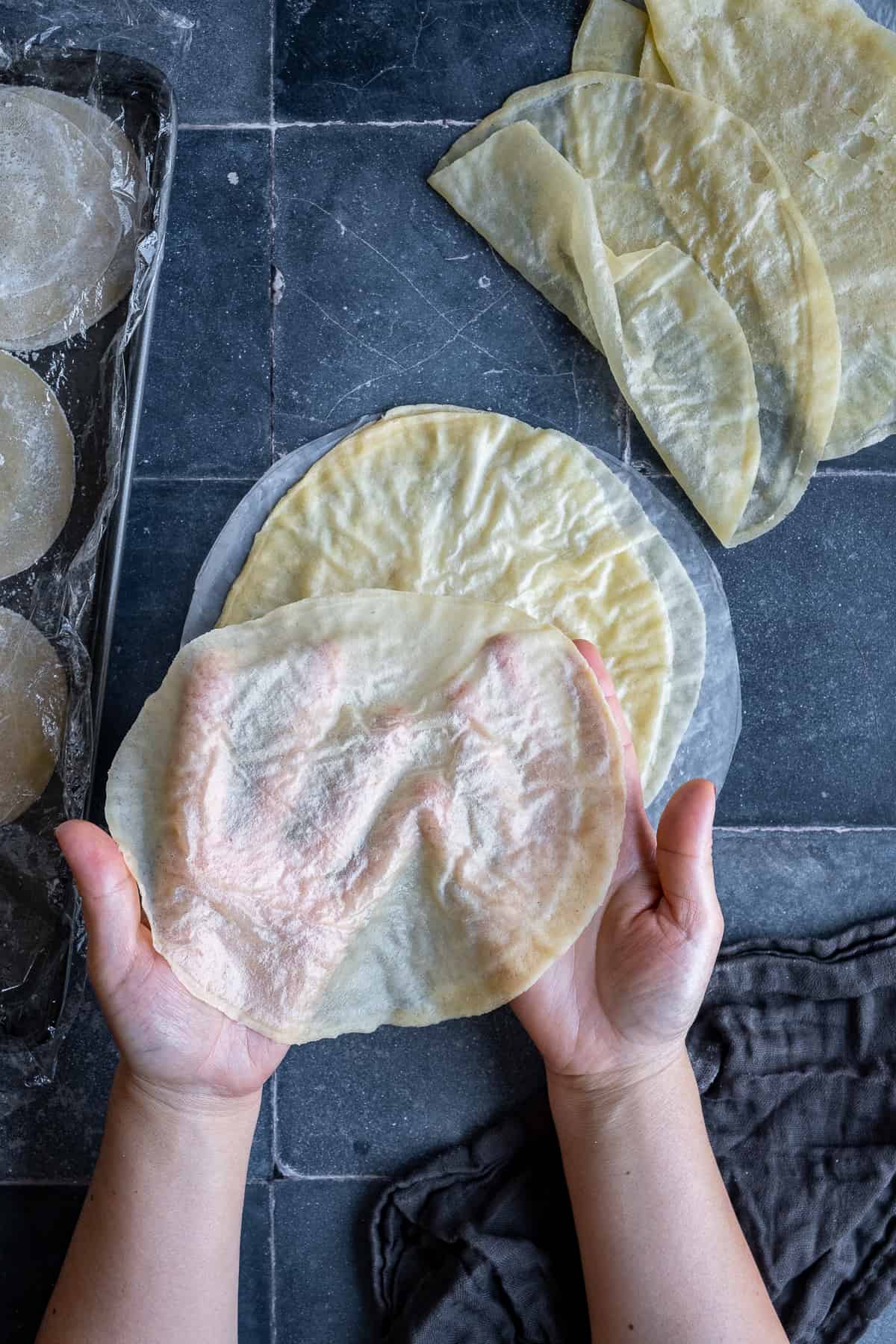 Woman hands showing how thin is a phyllo sheet.