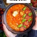 A bowl of tomato rice soup topped with cherry tomatoes, basil, and croutons, held in hands, with text "Tomato Rice Soup" and "giverecipe.com".