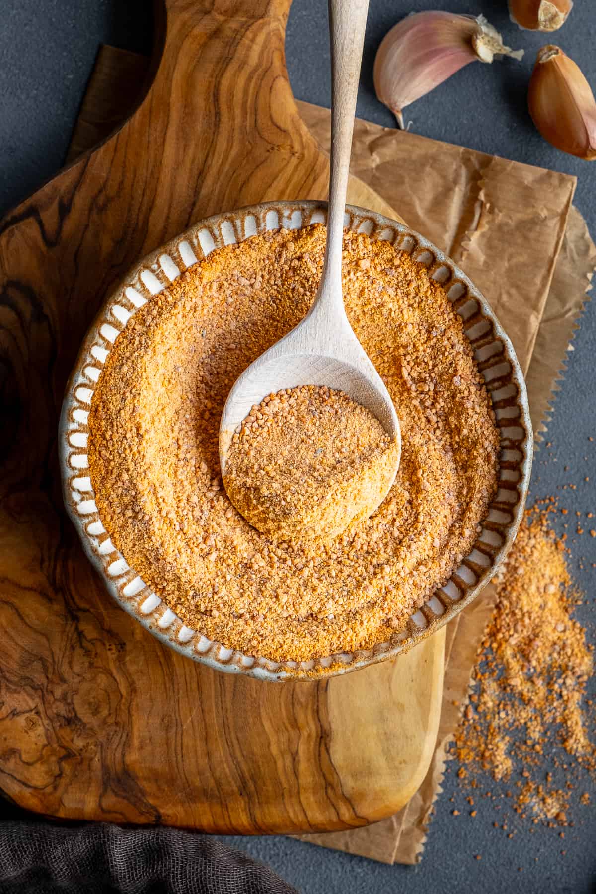 Tarhana soup powder in a small bowl and a wooden spoon in it.