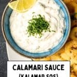 Close-up of creamy Turkish calamari sauce garnished with herbs and a lemon wedge, served with crispy fried calamari rings.