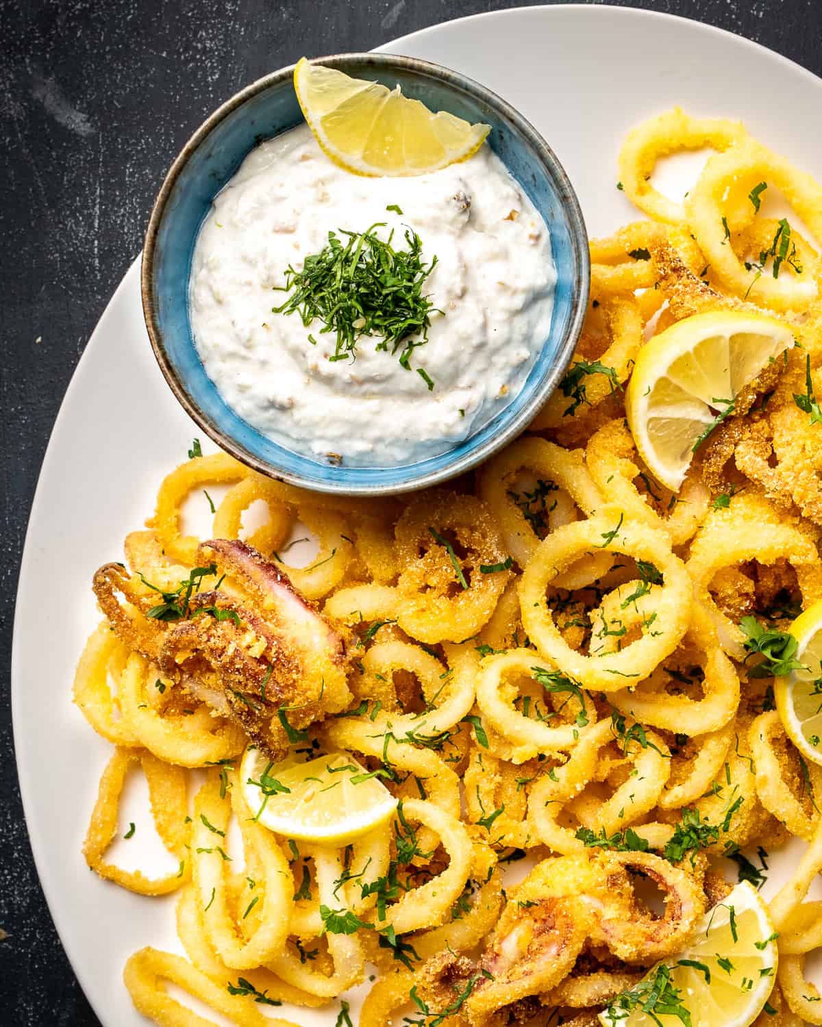 Tarator sauce served in a bowl as a condiment on the side of fried calamari.